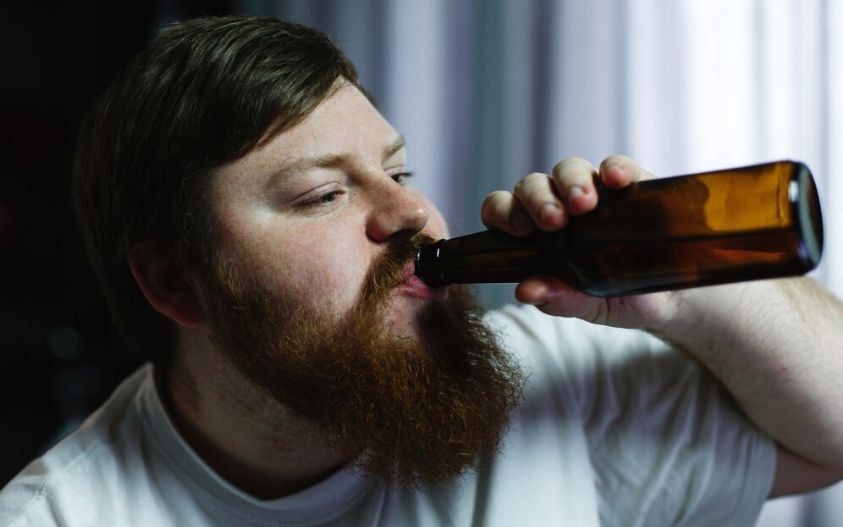 Fat man drinks beer